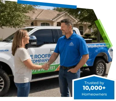 The Roofing Company of Tampa Bay owner Matt Lentz shaking hands with a satisfied customer in front of a branded company truck. Trusted by 10,000+ Tampa Bay homeowners since 2014.